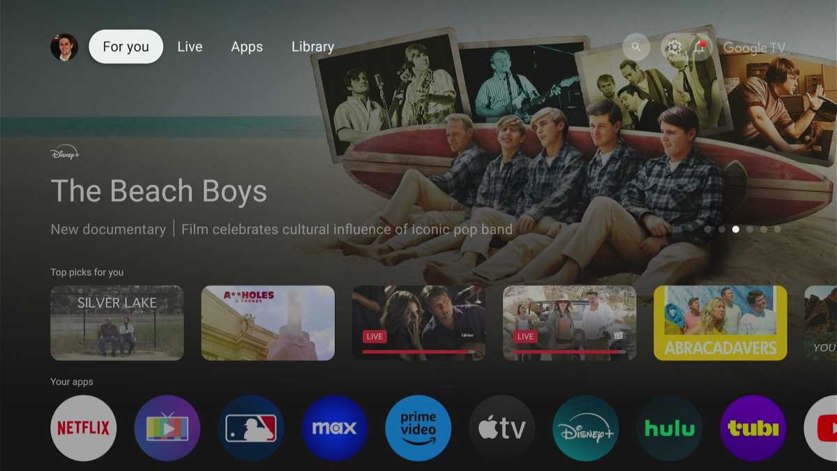 Google TV home screen with feature carousel, top picks, and apps