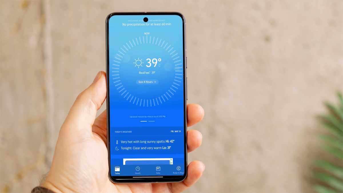 A smartphone showing hot weather on a weather app