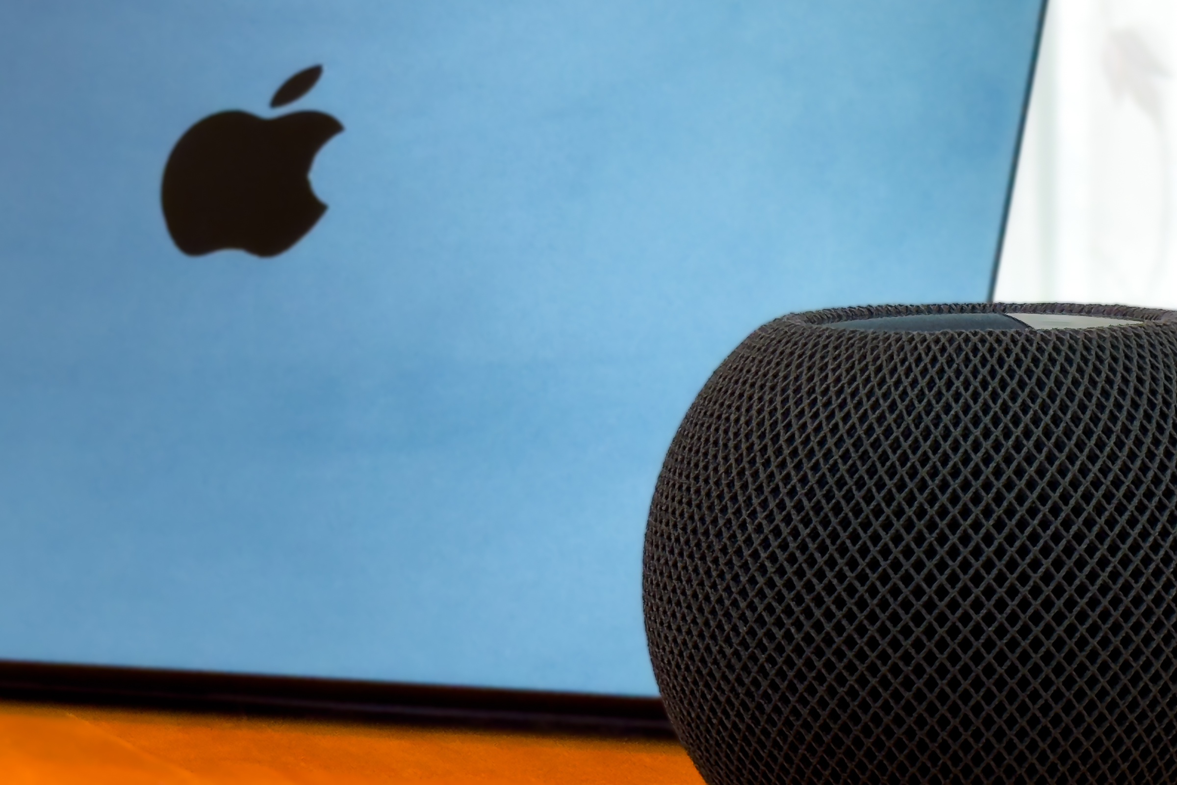 HomePod next to back of an iPad