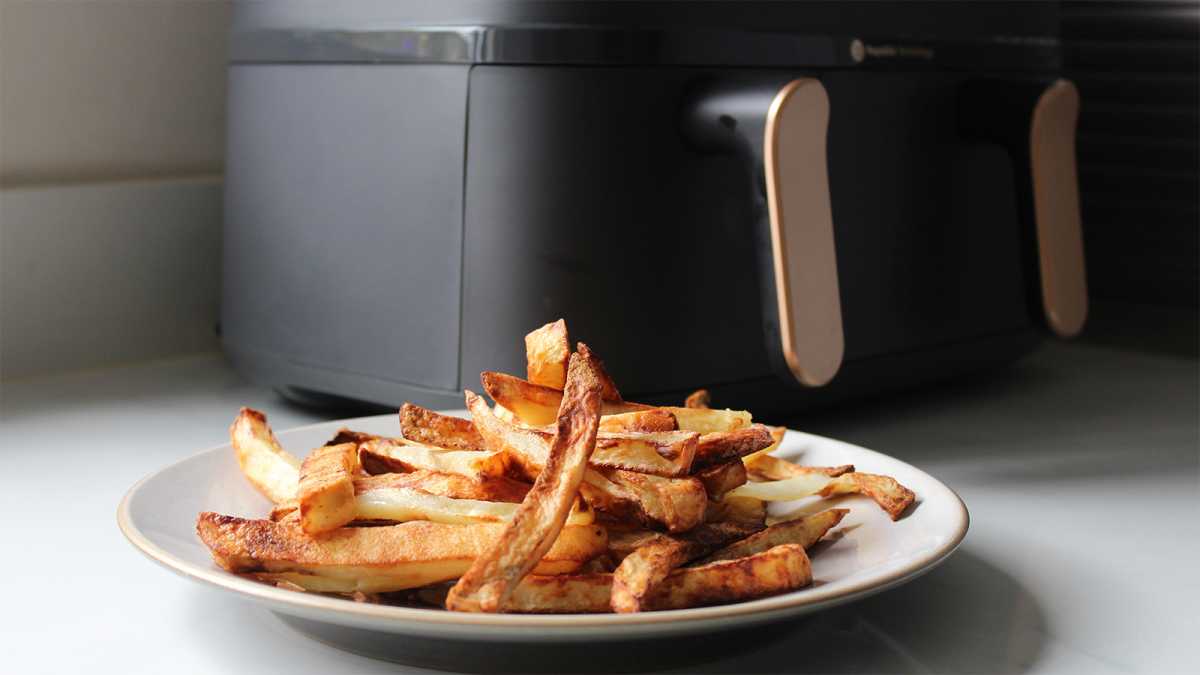 A plate of chips in front of the air fryer