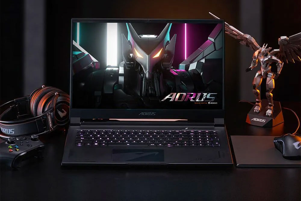 Aorus gaming laptop on gaming desk with gaming peripherals