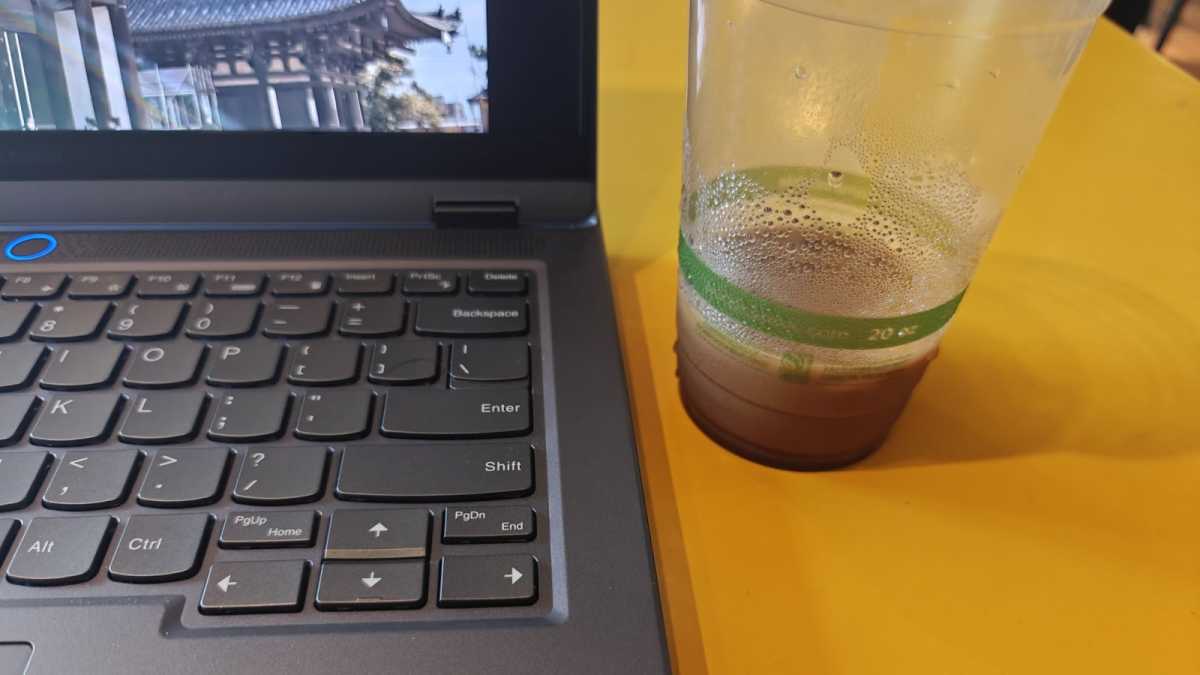 Cold condensation on cup next to laptop