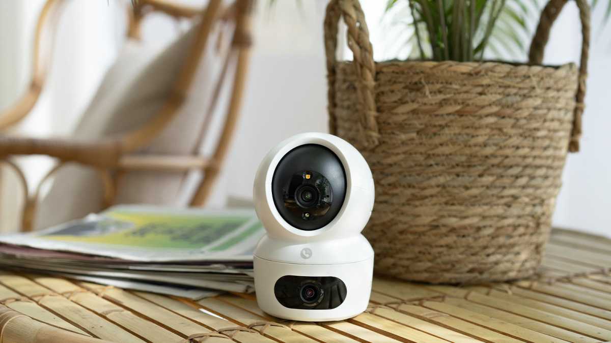 EZVIZ H7c dual-lens indoor camera on a table in front of a plant