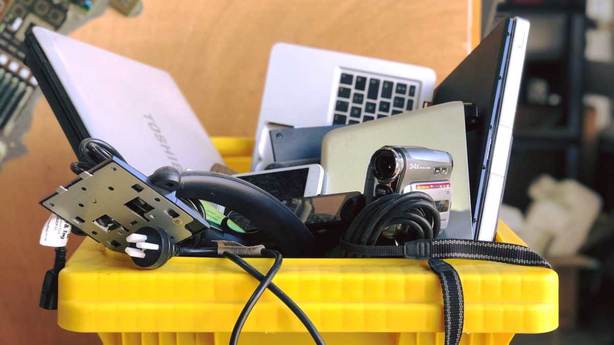 Laptop and other electronics tossed into a recycling bin