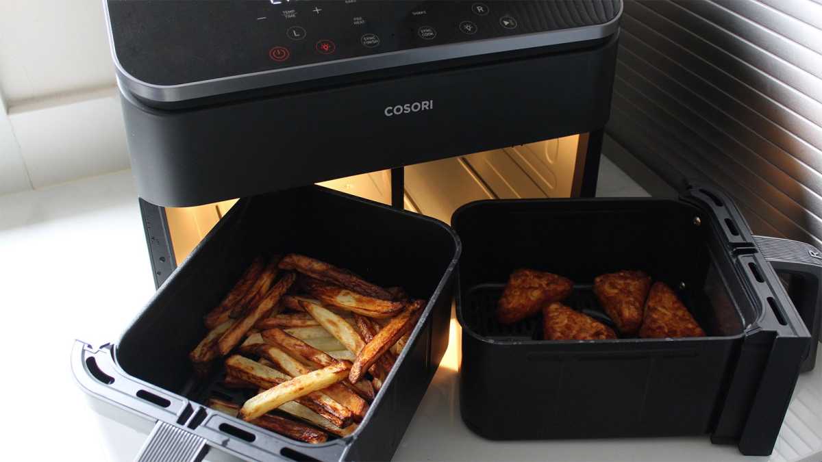 Fries and hash browns in the baskets of the air fryer