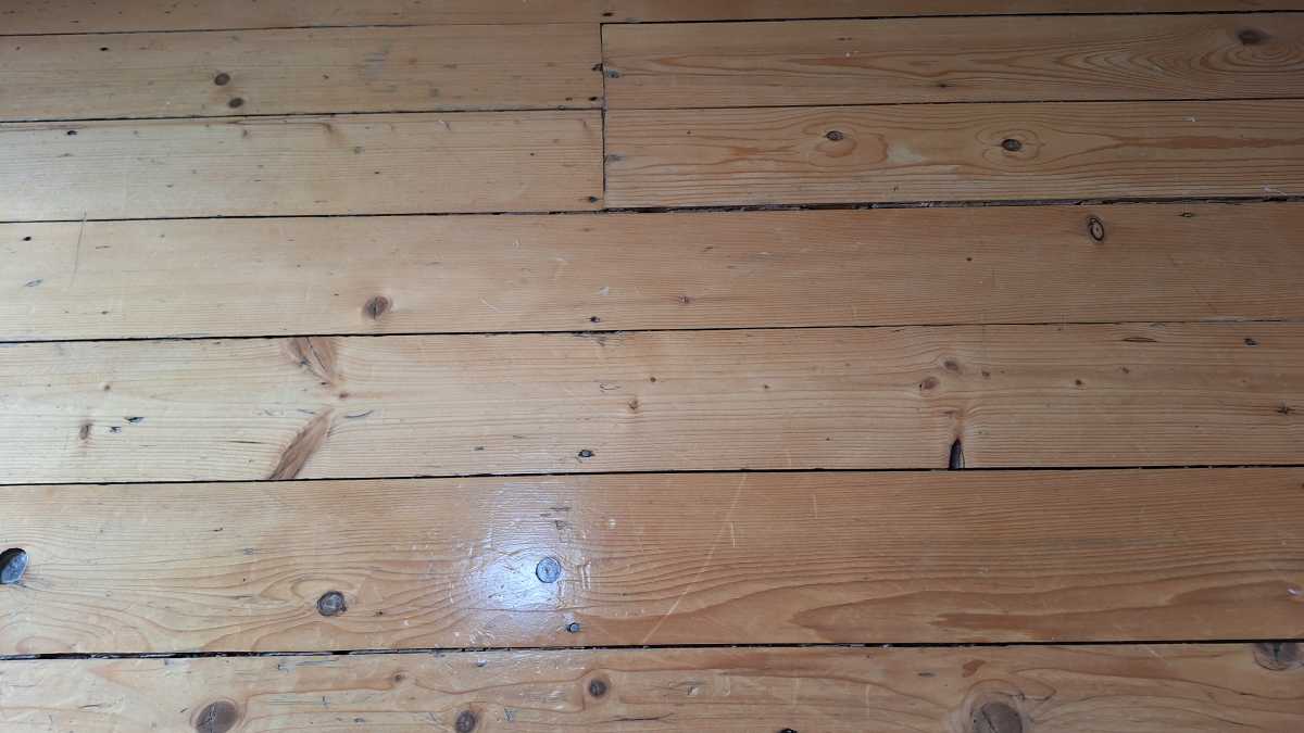 A hardwood floor showing the result of the Tineco iFloor 5 Floor Washer flour test.