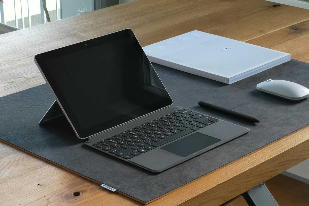 Blank Surface Go laptop on wooden desk workspace