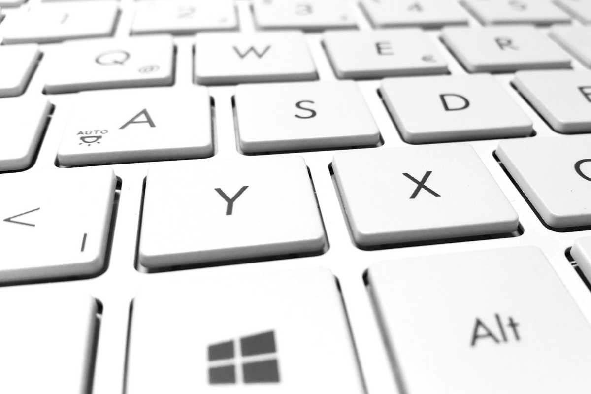 Closeup of white laptop keyboard with Windows key prominent