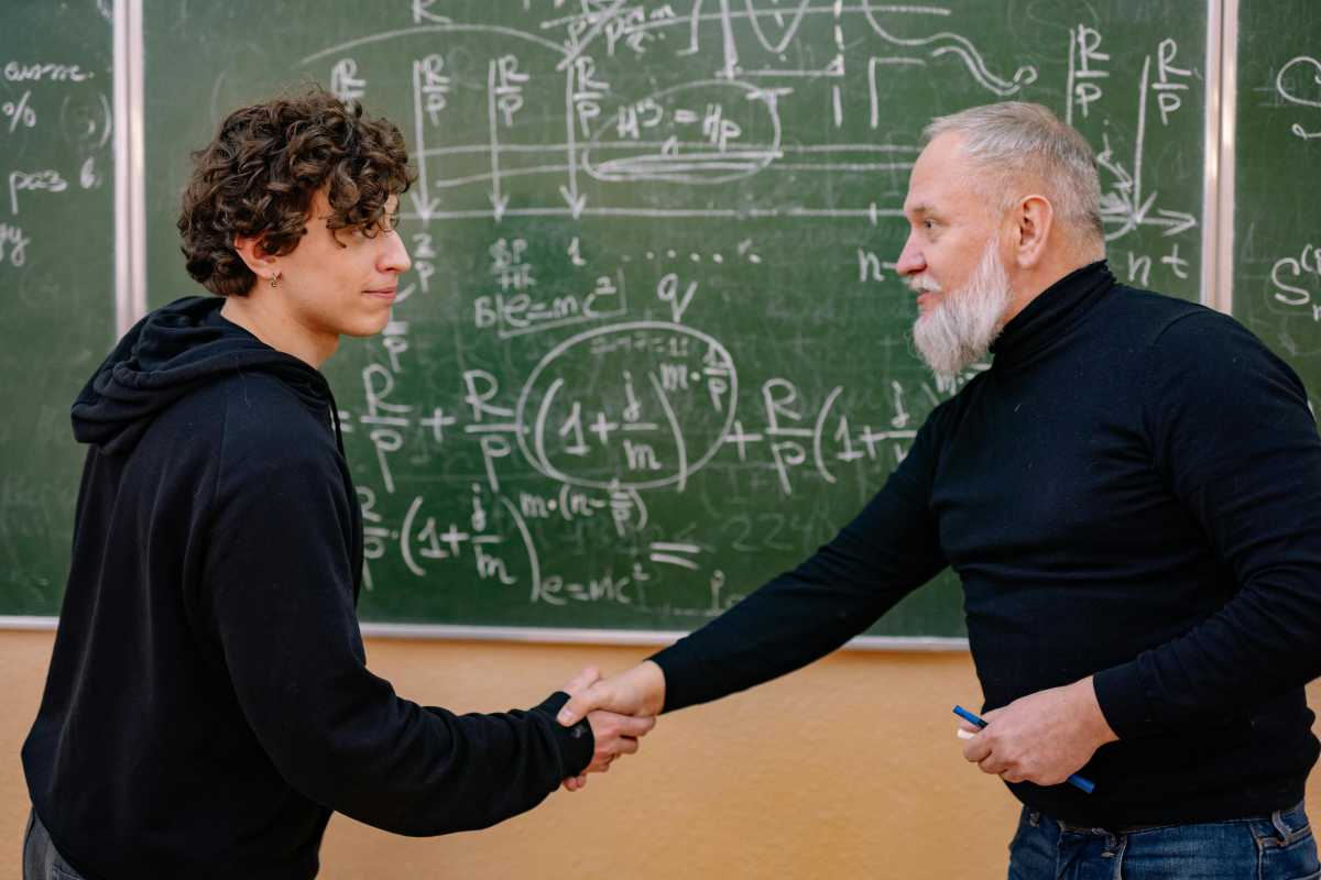 teacher shaking hands with student