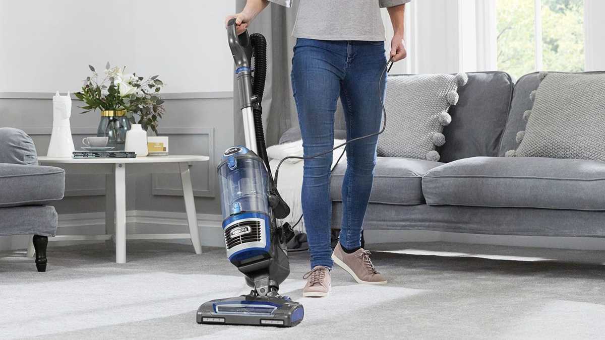 A woman vacuuming her carpet