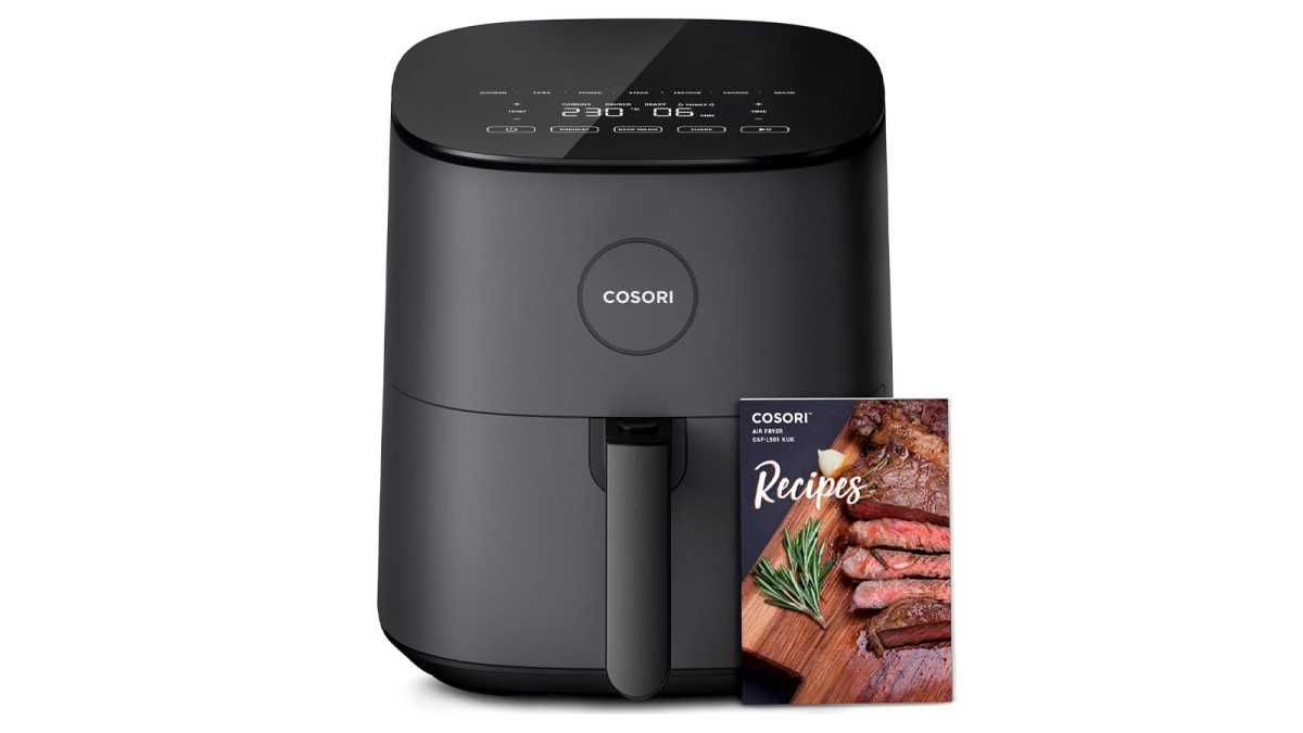 Cosori air fryer seen from front, with recipe book