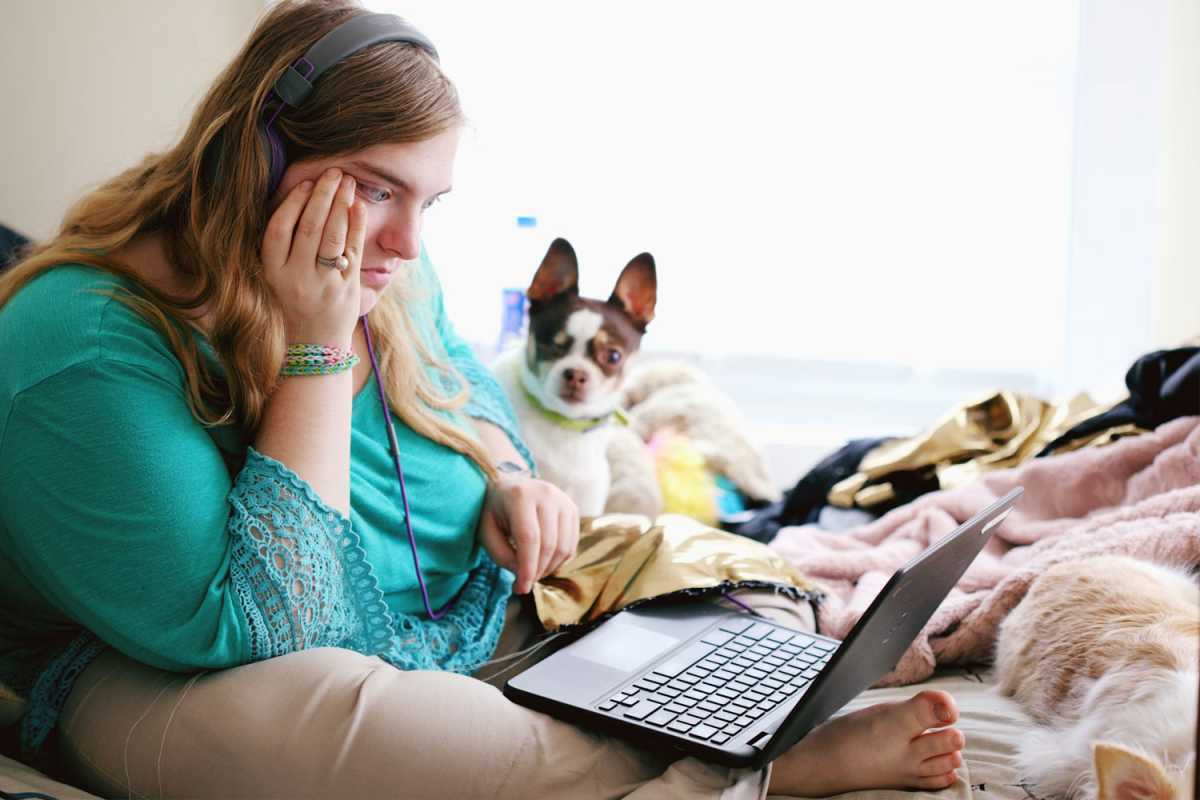 Woman unhappy with the laptop she's using on her lap