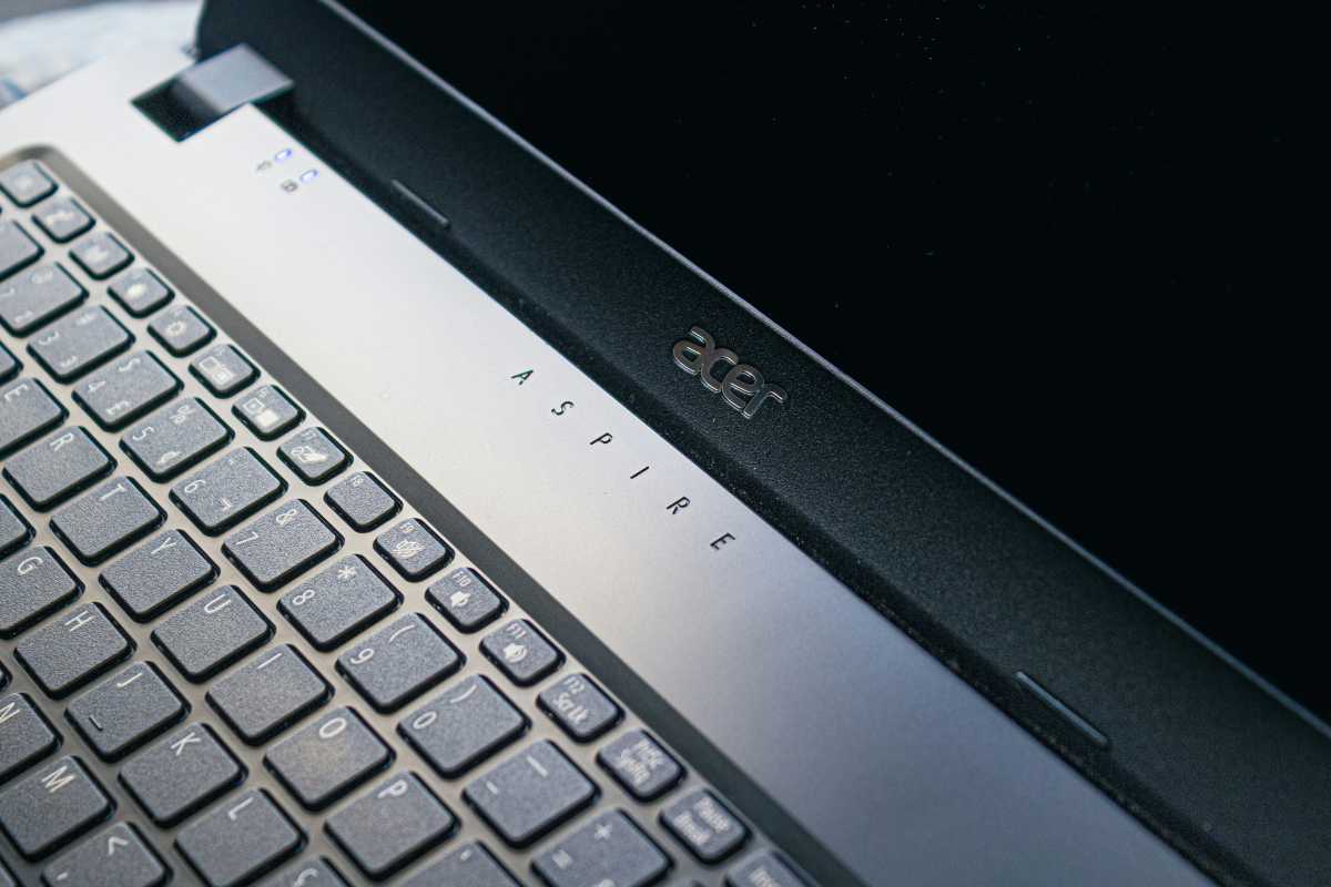 Acer Aspire logo and branding in dramatic lighting on laptop hinge