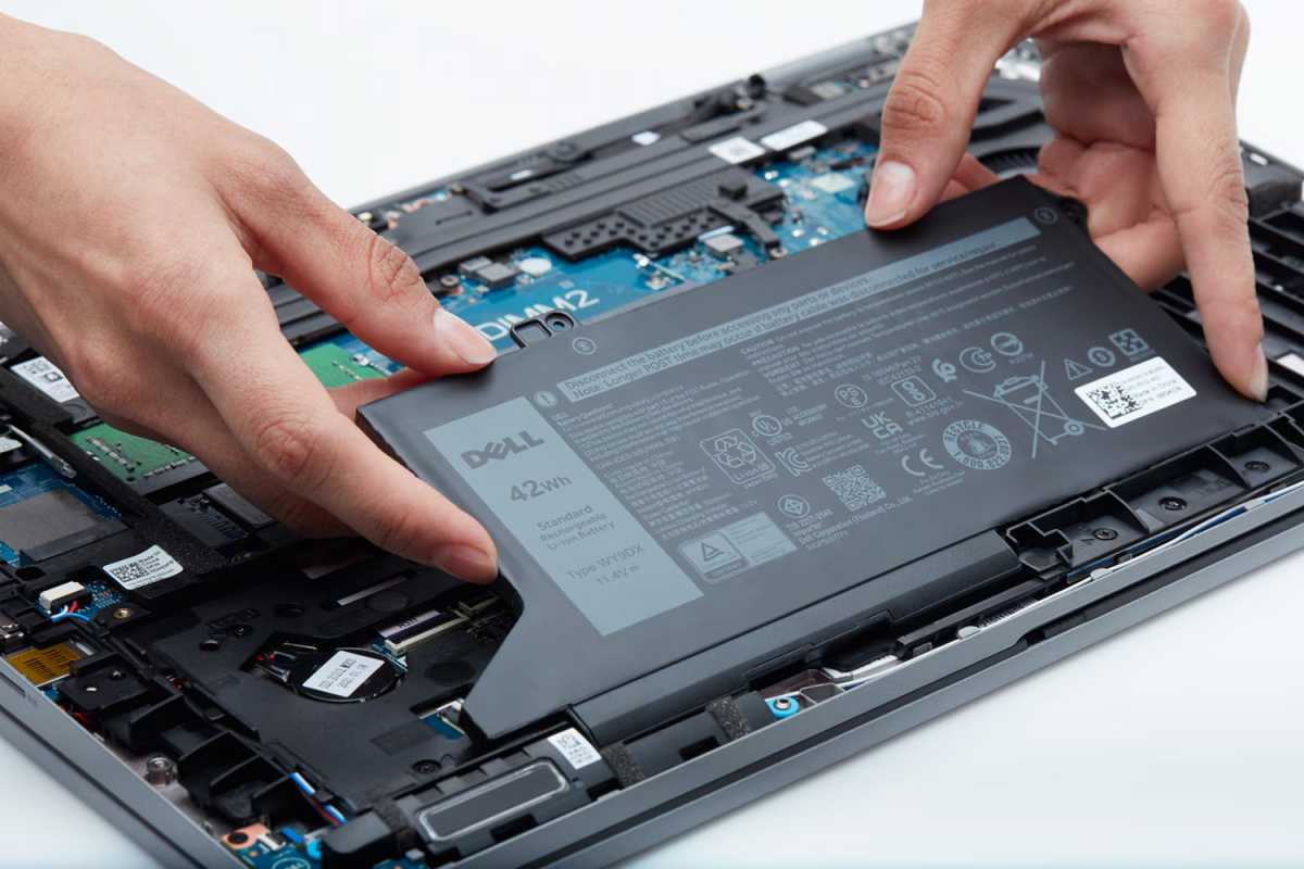 Dell laptop opened up and internal components being easily removed by hand