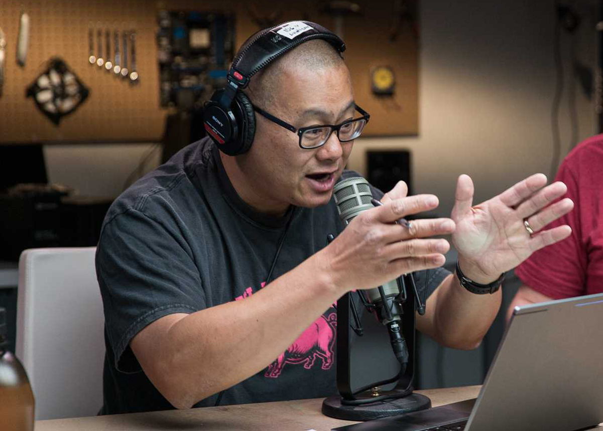 Gordon Mah Ung, animated with his hands raised