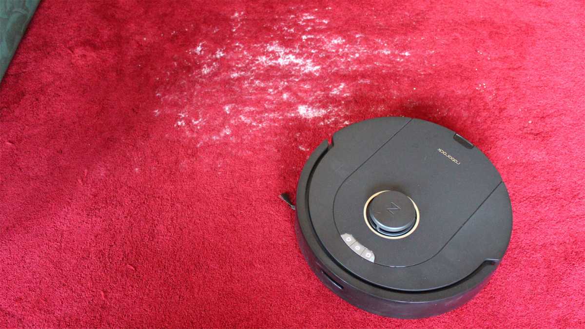 The Q5 Pro on a red carpet, with visible flour left behind after cleaning