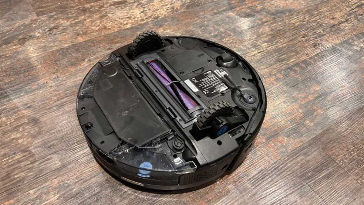 The robot vacuum cleaner is upside down