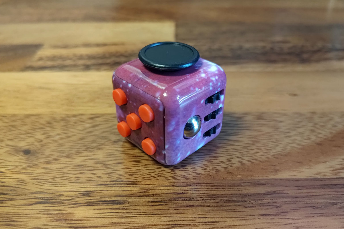 Classic cube desk fidget toy on wooden table