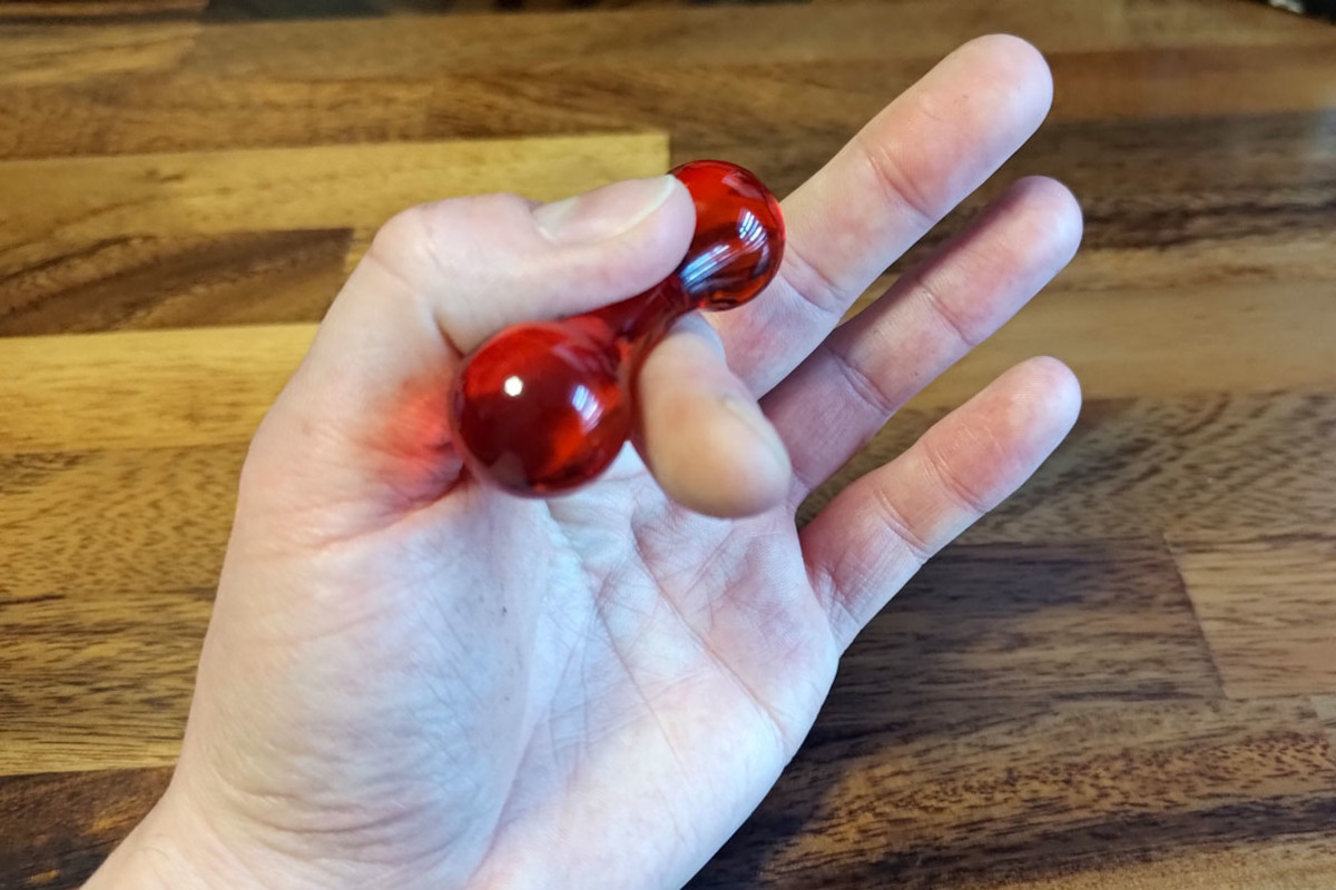 Knucklebones desk fidget toy in hand