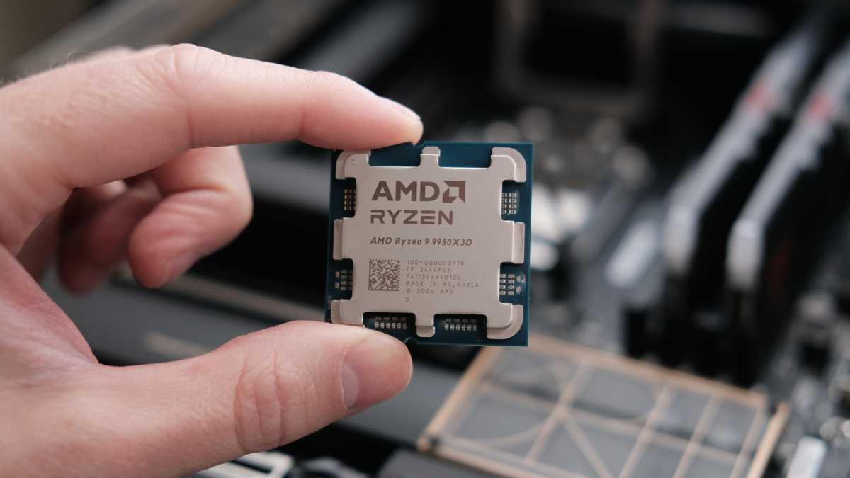 AMD Ryzen 9 9950X3D held in a hand - centered