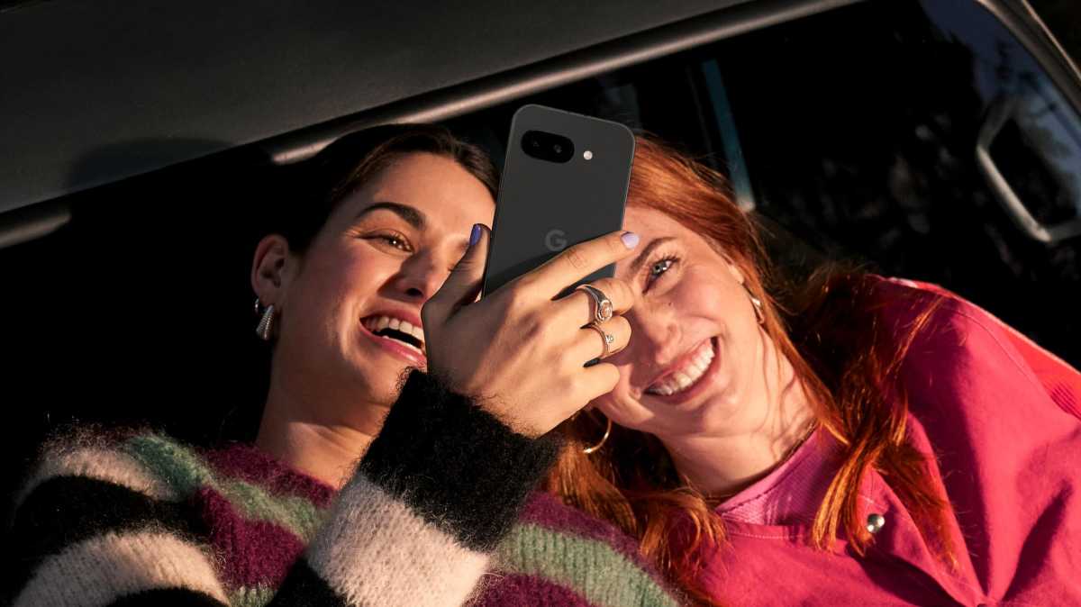 A woman holding the Google Pixel 9a