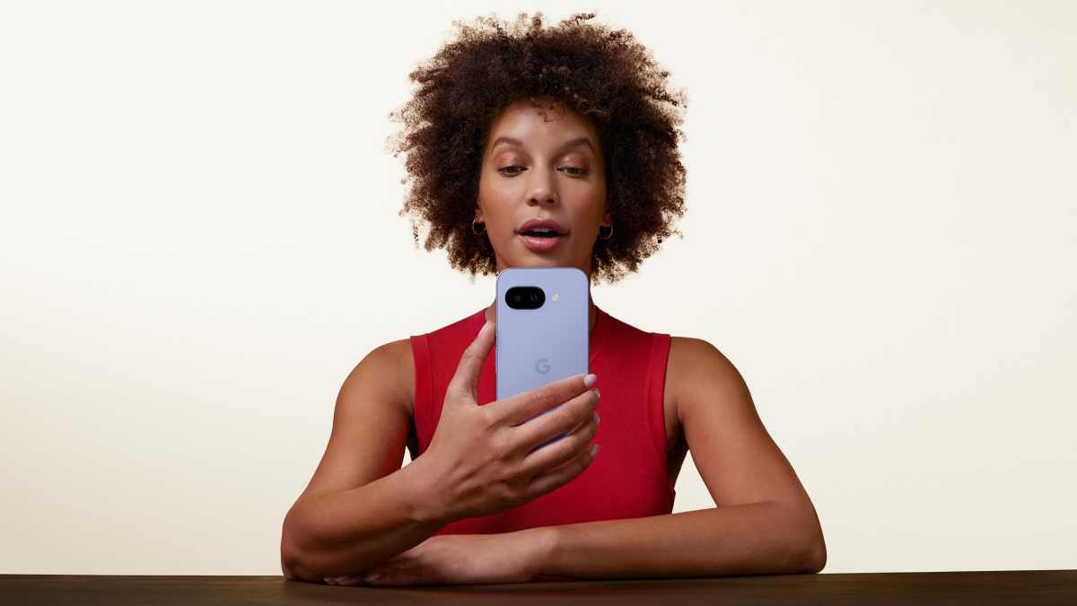 A woman holding the Google Pixel 9a