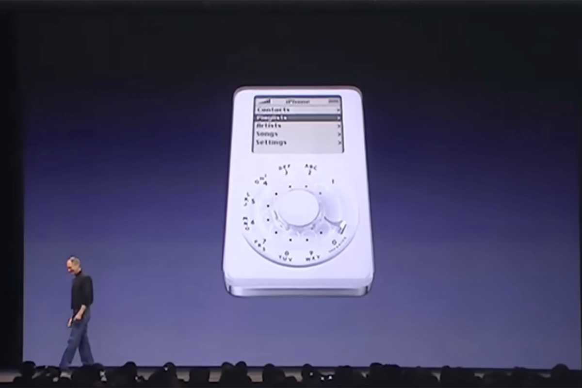 Steve jobs alongside a joke slide showing an iPod with a rotaty phone dial