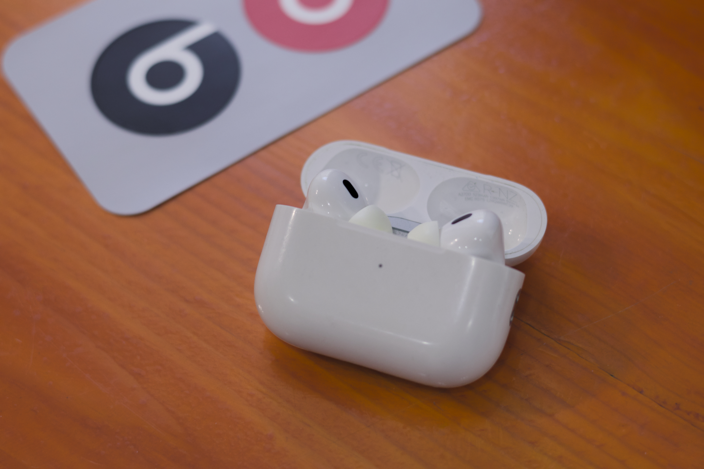 AirPods Pro 2 next to Beats logo stickers