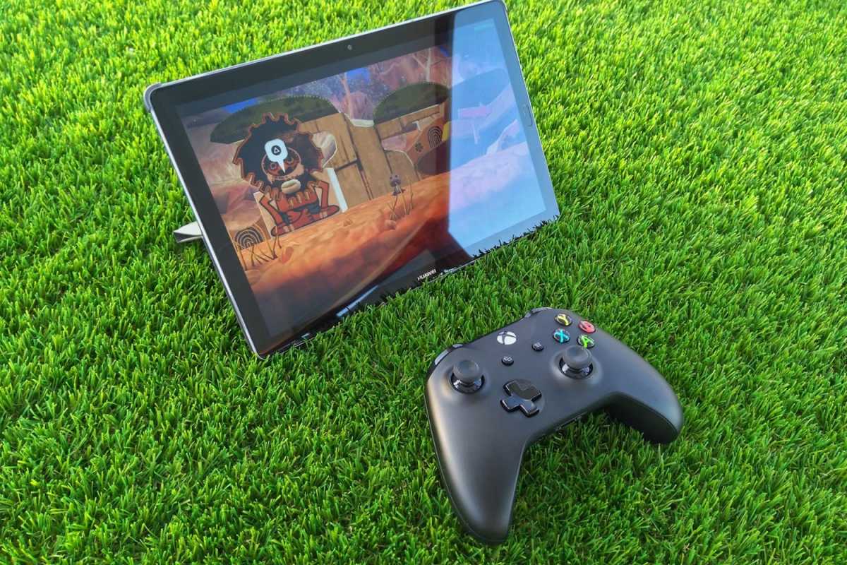 Cloud gaming with Xbox controller and Huawei tablet on grass