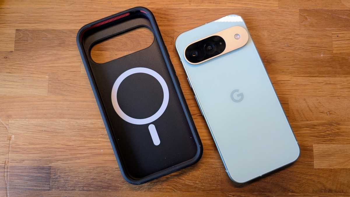 A MagSafe charging case next to a green Pixel 9 on a desk