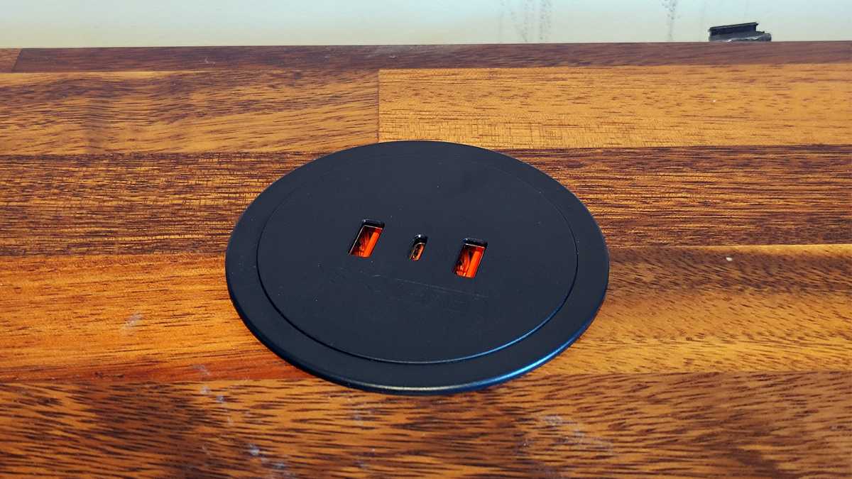 Uplift Pop-Up Power Grommet black installed in a wooden desk