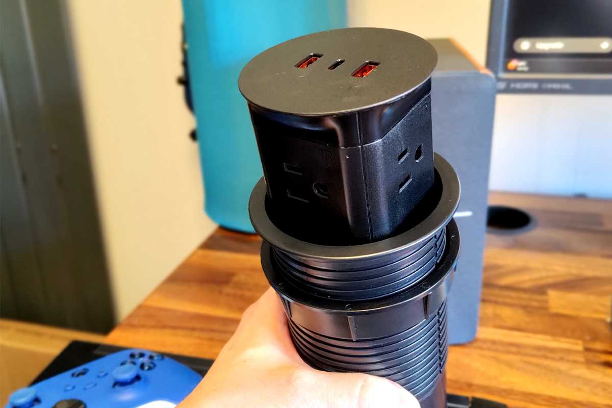 Uplift Pop-Up Power Grommet in hand and before installation