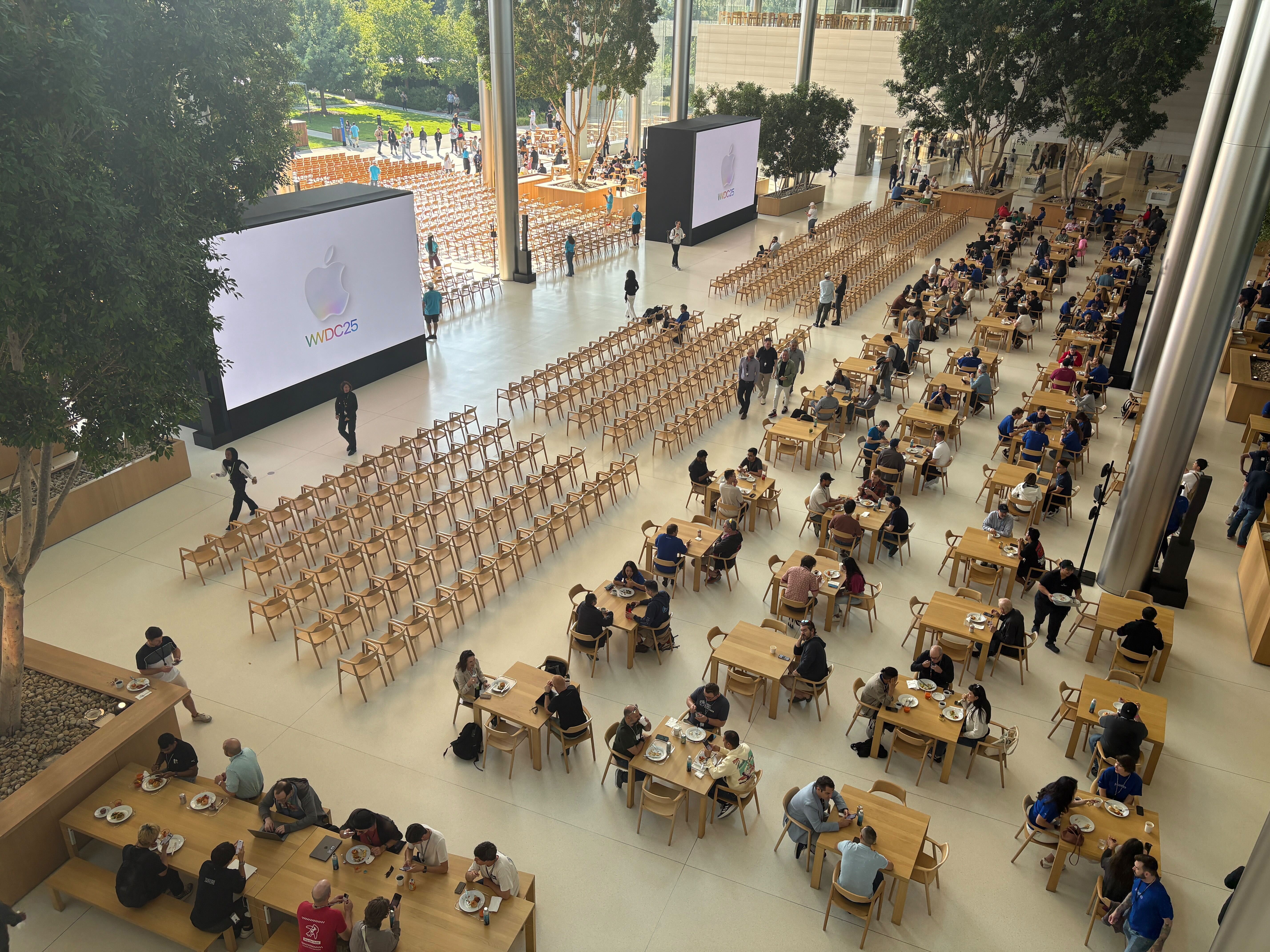 Attendees gather to watch the WWDC keynote at Apple Park.