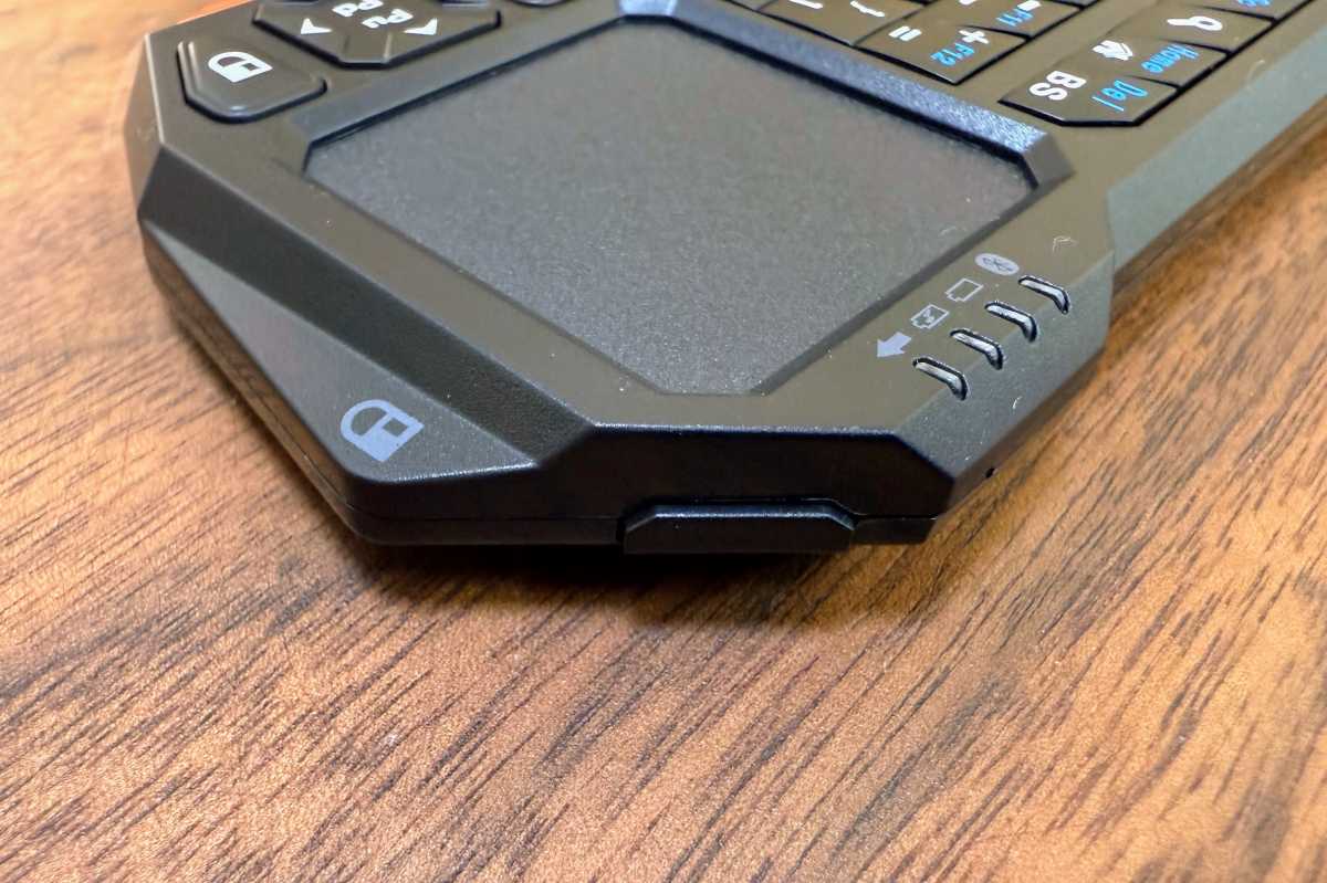 Close-up of the top edge of a mini keyboard remote, showing a shoulder button for triggering mouse clicks.