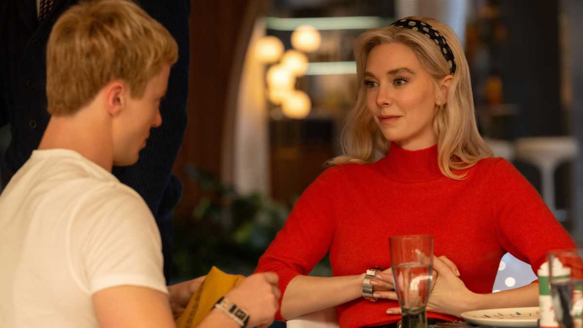 Sue Storm and Johnny Storm sitting at a table talking.