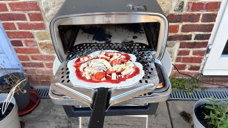 Pizza going into oven