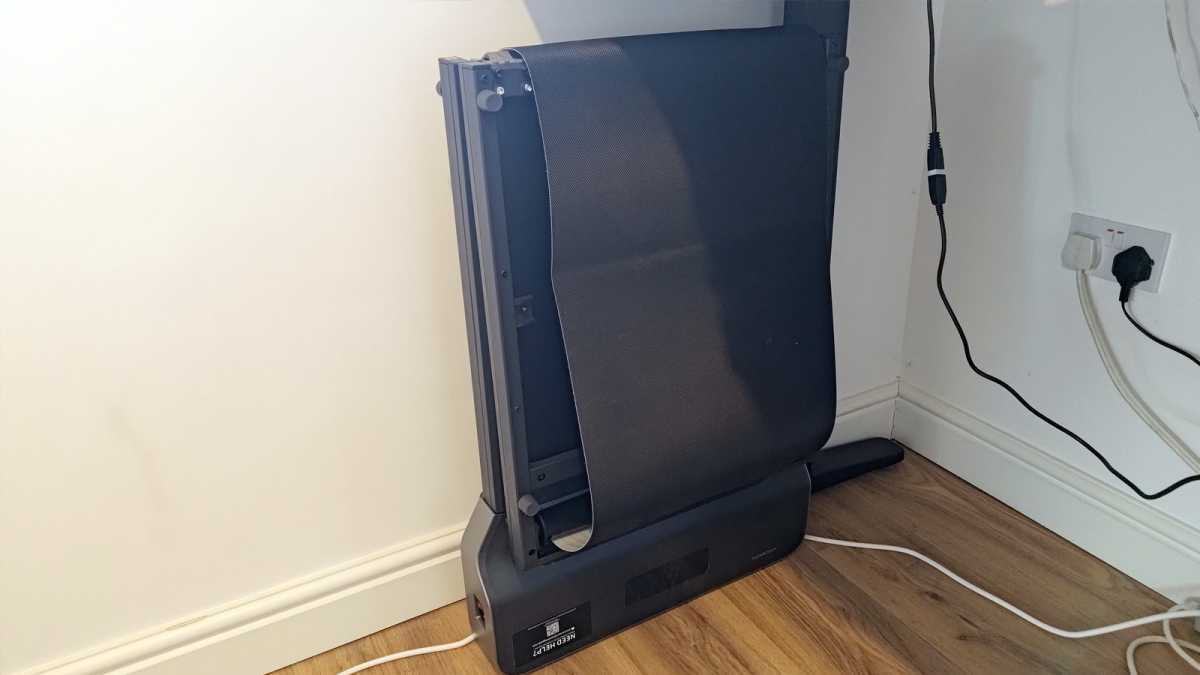 WalkingPad Z1 standing desk treadmill folded against wall