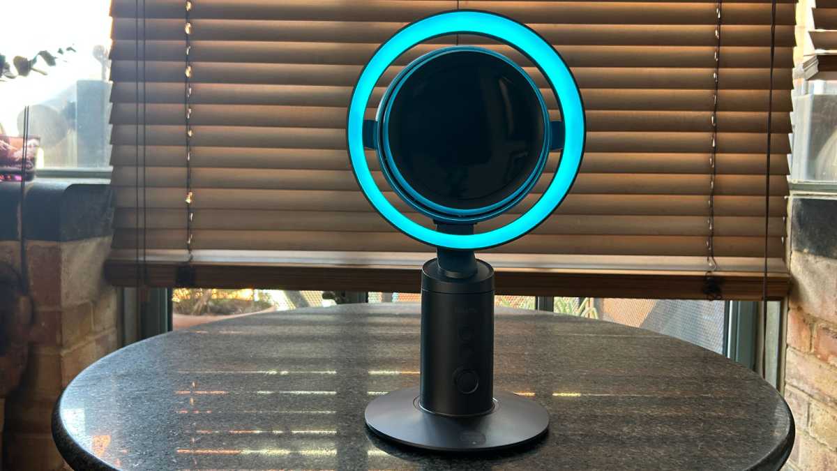 The fan's ring light illuminated in turquoise