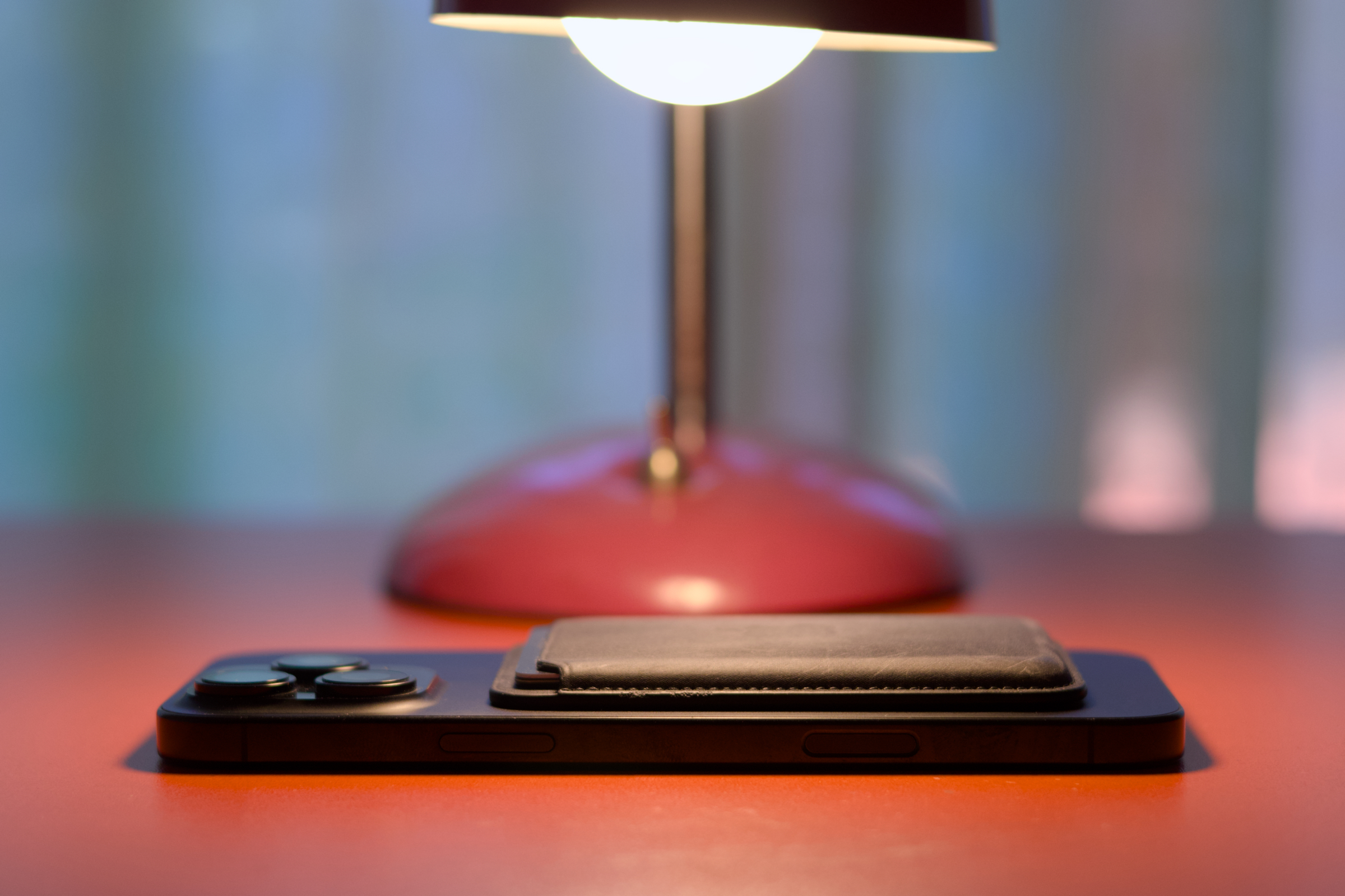 iPhone with MagSafe wallet attached under a lamp