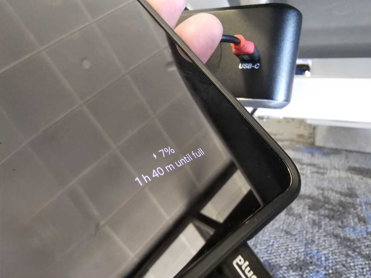 carregando em um aeroporto com um cabo somente de dados