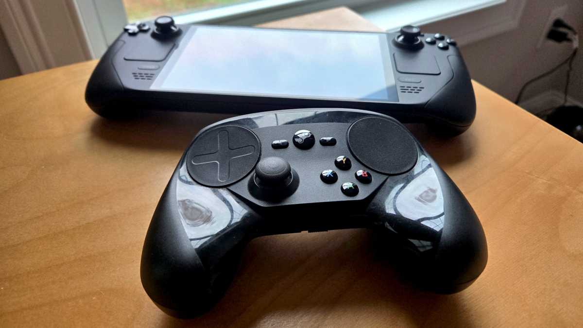 Steam Controller and Steam Deck on corner of wooden desk