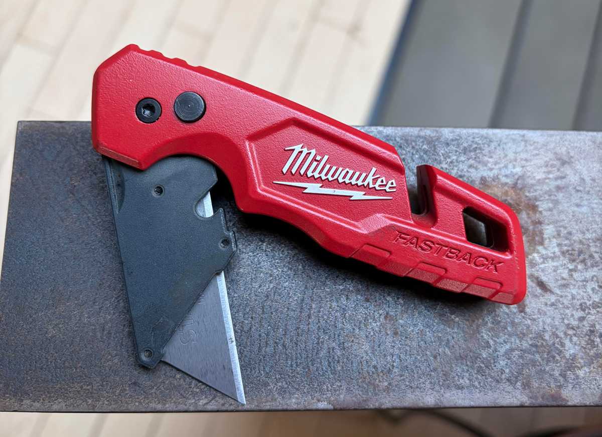 The Milwaukee Fastback Knife resting on metal