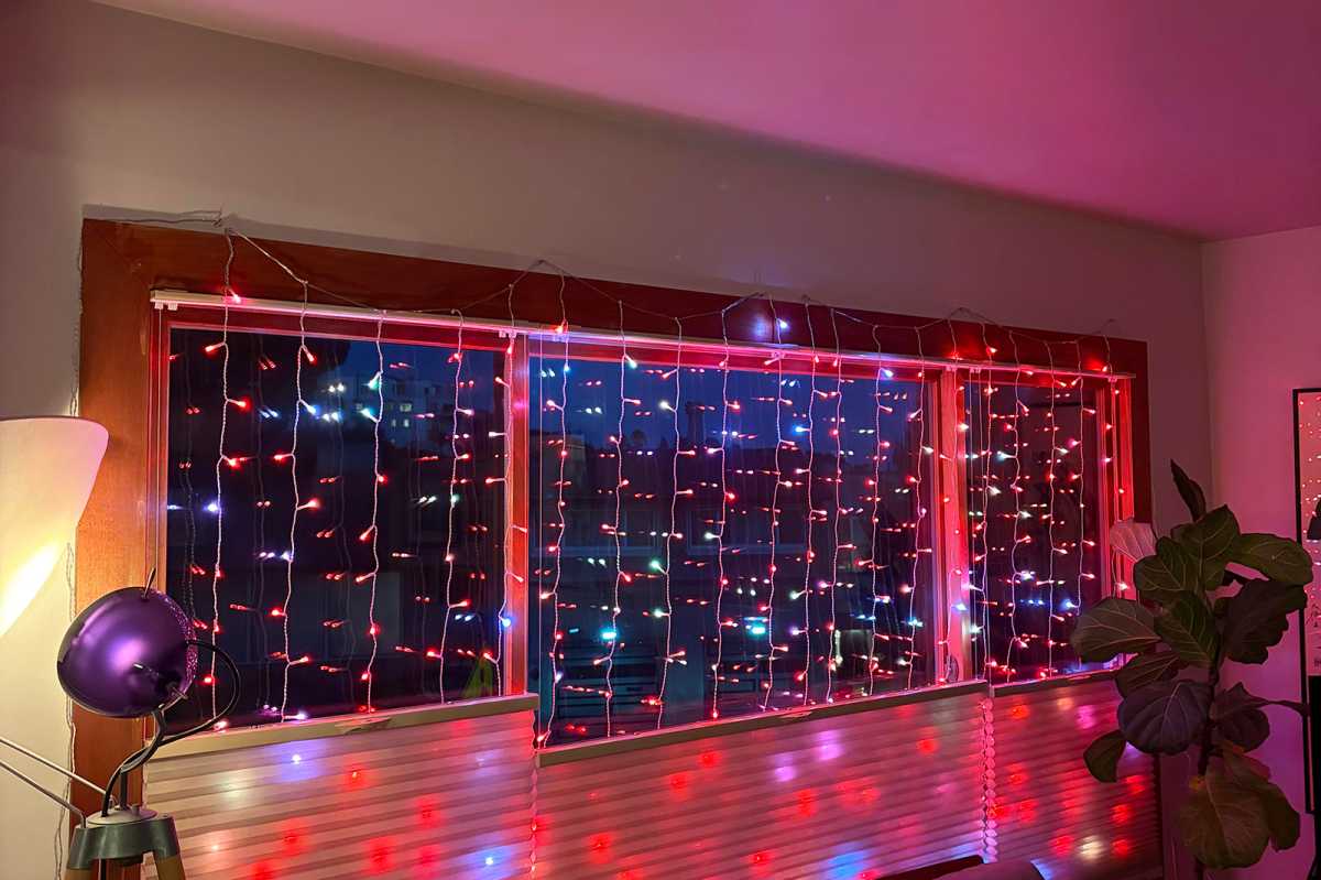 Twinkly string lights in a festive, Christmas window setting