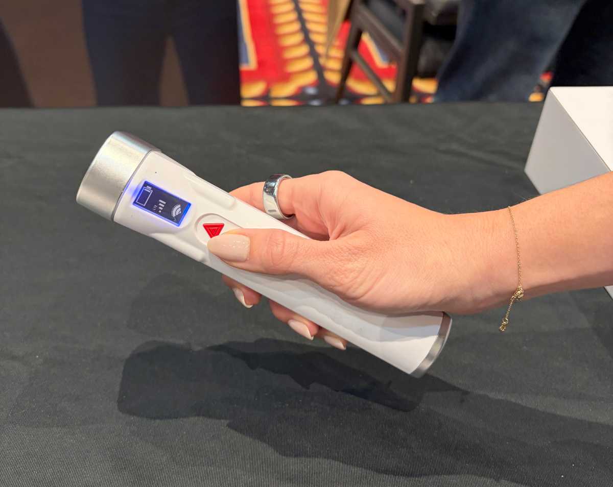 A woman holding the Timeli hardware in her hands.