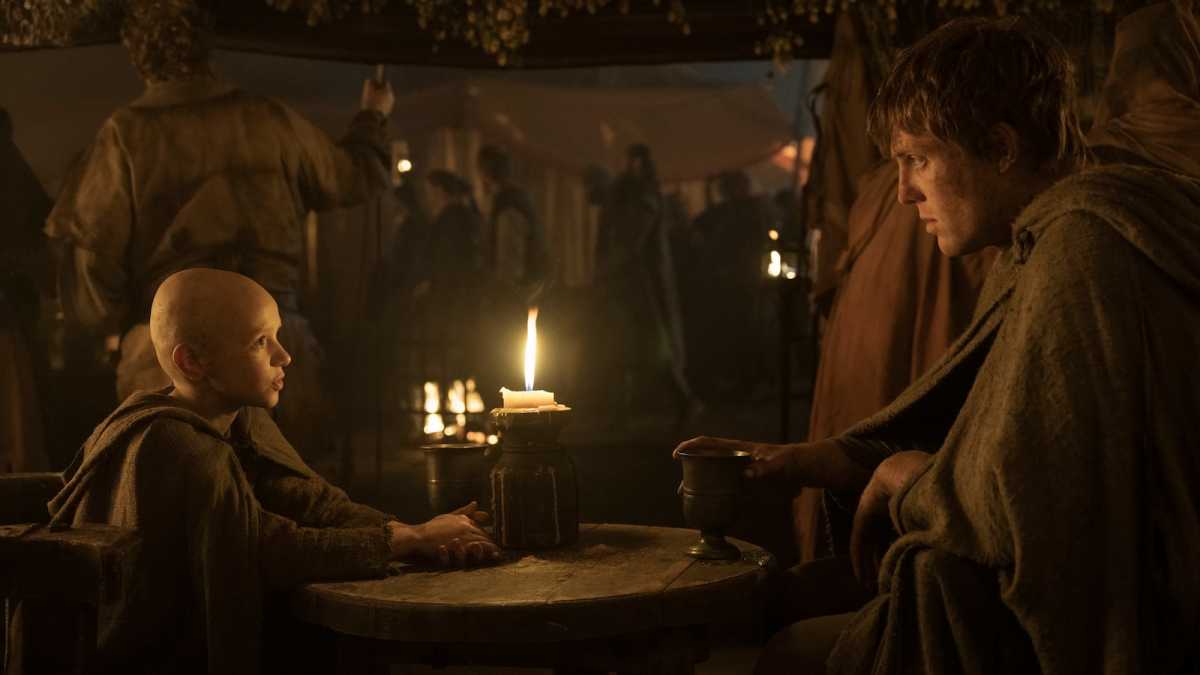 The young squire and knight sitting at a table in an inn