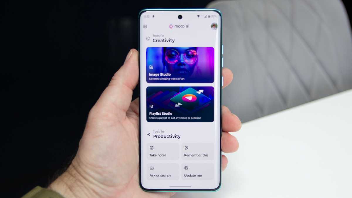 A hand holding the phone, with Moto AI on its display