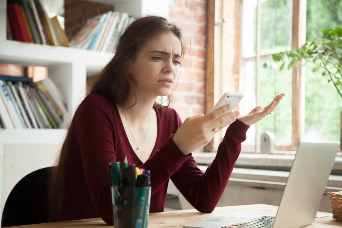 Verwirrte Frau mit Smartphone