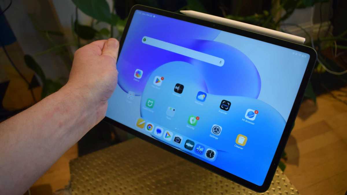 The Xiaomi Pad 8, held in a man's hand.