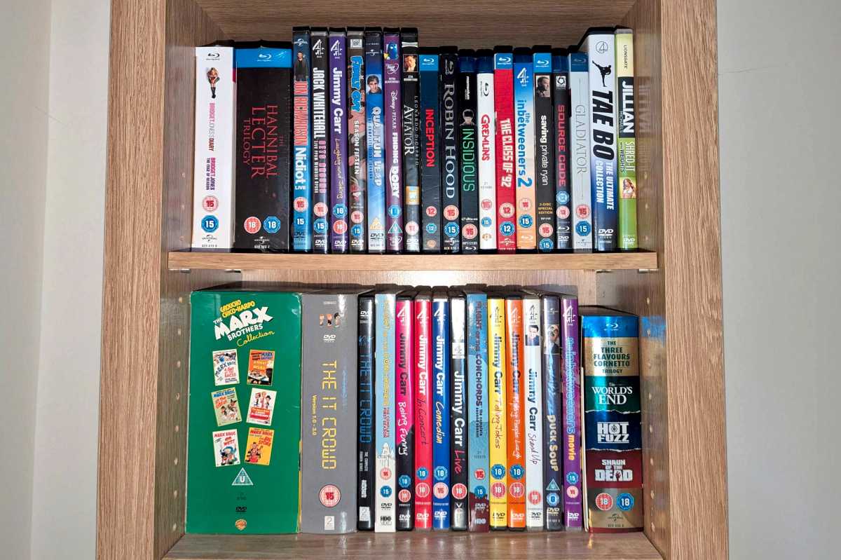 DVDs and Blu-rays selection on wooden shelf