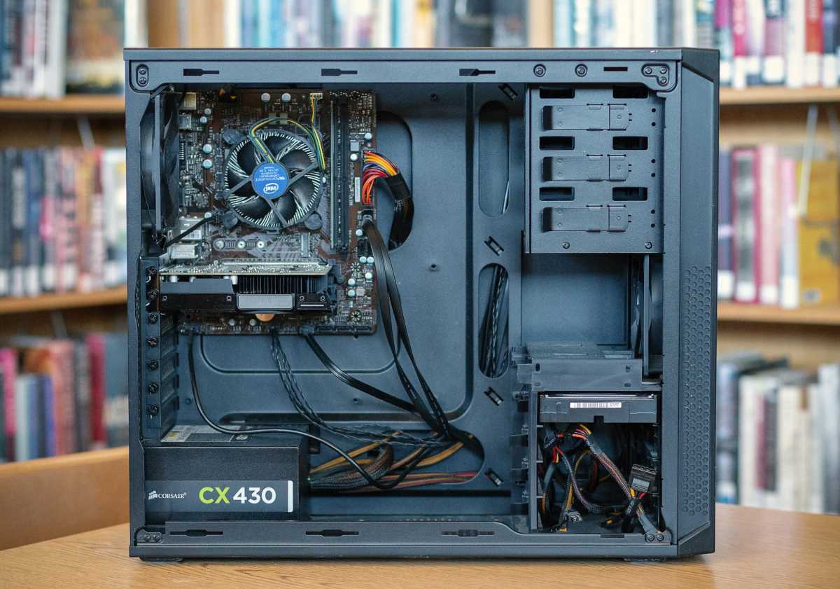 Desktop PC with internal hardware components exposed on wooden table